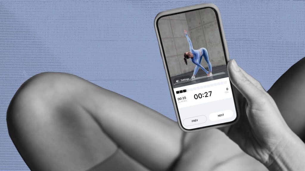 Black and white close up photo of person holding a smartphone while sitting cross-legged on the floor, smartphone displays BetterMe workout in progress. Image isolated on pale lined blue background