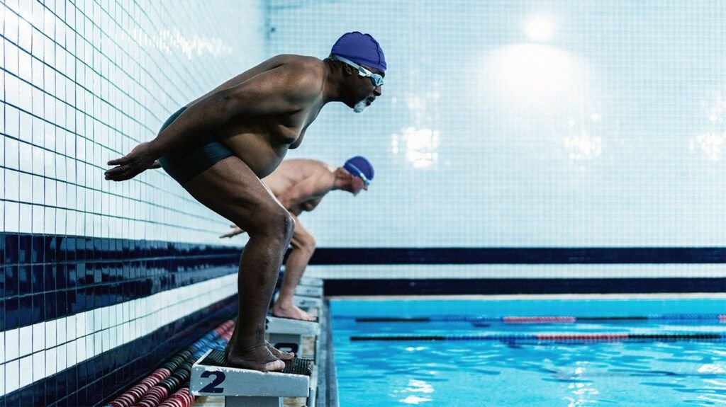 Senior men diving in the swimming pool
