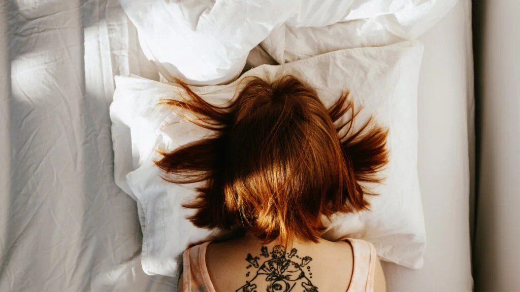 person laying face on pillow