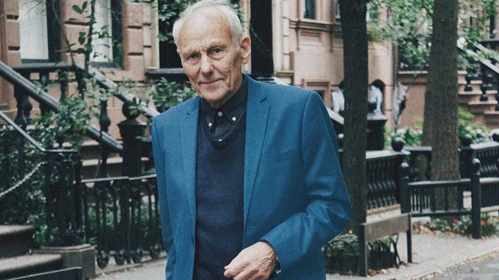 A senior outside a brownstone building in New York, which is where Healthfirst offer Medicare Advantage. -1