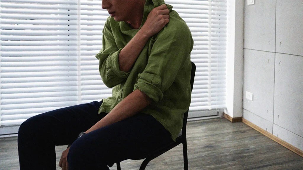 Male in a chair looking upset