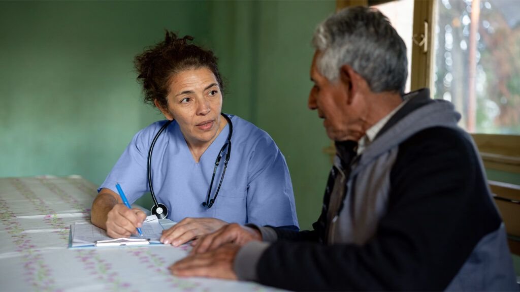 A doctor writing a prescription for an older man-1